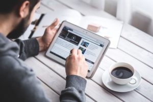 Person exploring updated and expanded blog content on their tablet.