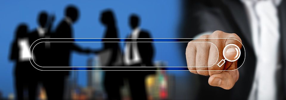 Businessman pointing to a search tab, with other moving entrepreneurs in the background.