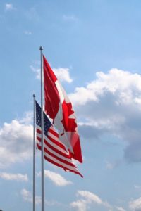 American and Canadian flags next to each other.