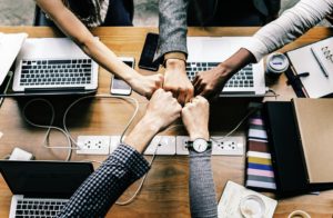 Unity among co-workers through fist bumps.