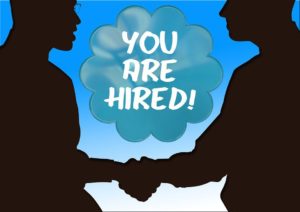 Two men, shaking hands, with a You Are Hired cloud in-between them.