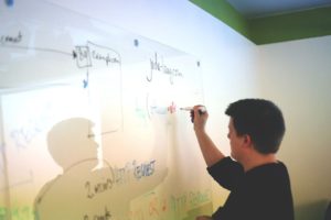 Man noting the plan for switching to HTTPS on a whiteboard.