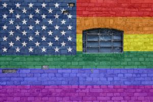 Wall painted in rainbow colours, with the american flag stars in the corner.