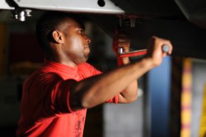 Guy doing maintenance on a machine.