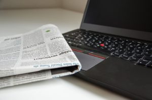 Newspaper on a laptop.