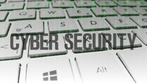 words cyber security written in the center, a keyboard in the background