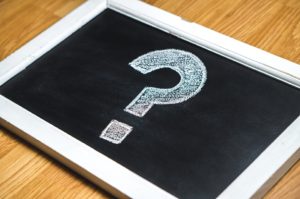 a white question mark on a black board symbolizing the question "Why do we need to know about the recommended website protection tools?"