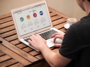 a person working at the computer and trying to find the recommended website protection tools