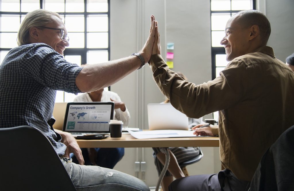 Two businessmen doing a high five