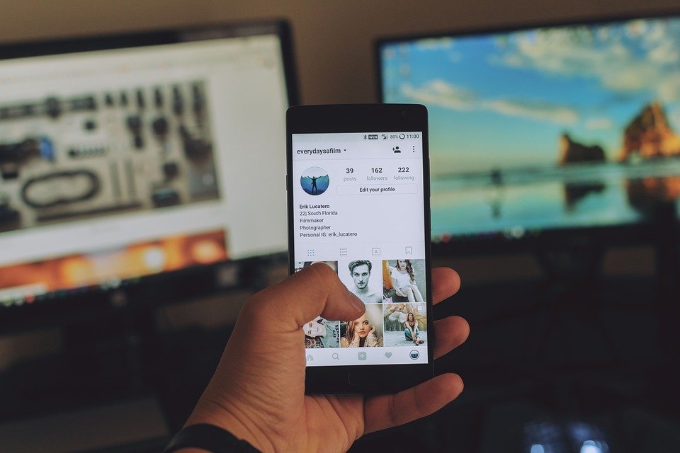 A person looking at an Instagram account on the phone.