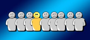 A happy cartoon person surrounded by unhappy ones, symbolically demonstrating one of the traits of a great mission statement for movers.