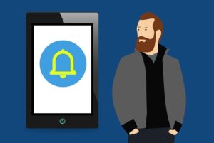 A drawing of a push notification on a mobile phone with a man standing next to it.
