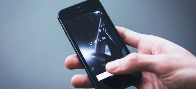A person using the Uber app on a smartphone.