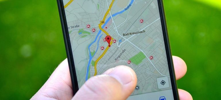 A person using a phone in order to find a certain location.