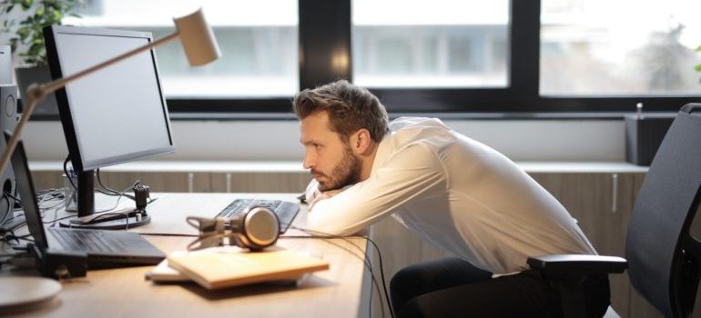 Person sitting and leaning on desk