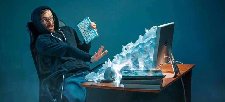 An avalanche of letters coming out of a laptop.