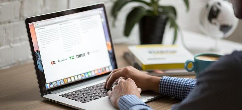 Person using a laptop to write guest blog articles.