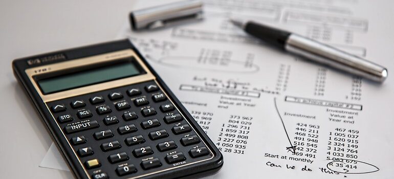 Calculator and pen on a budget plan.