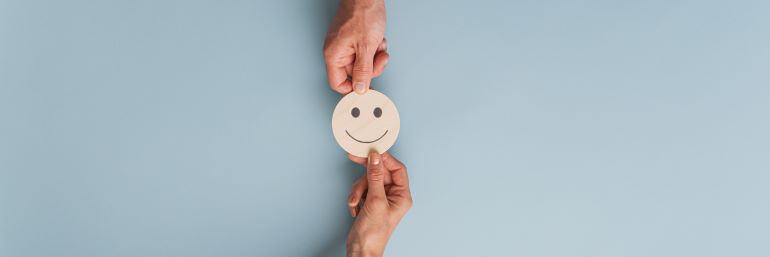 People exchanging a smiley face