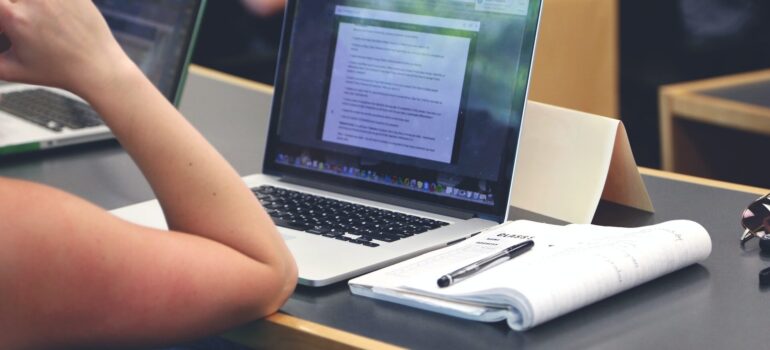 A person writing content on a laptop.