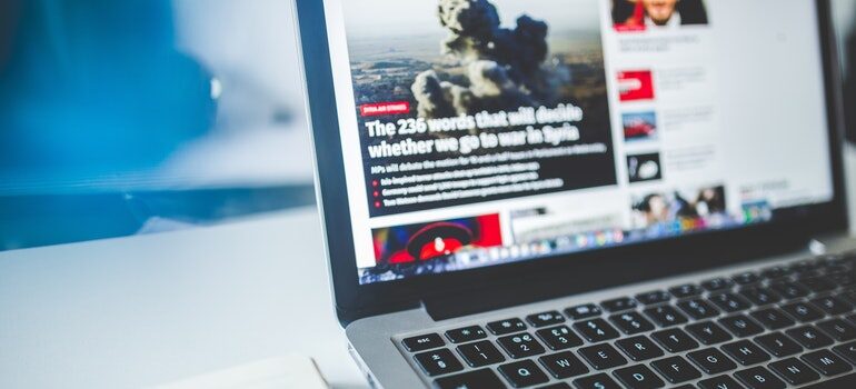 Laptop open to a news site.