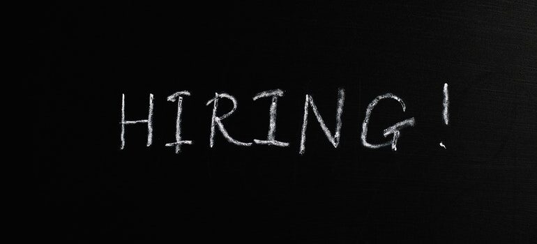 The word "hiring" on a blackboard.