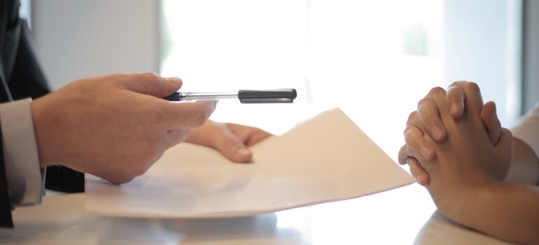 Person being offered to sign a contract.
