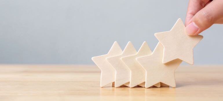 Person stacking little stars next to each other.