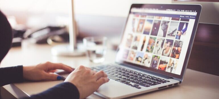 person looking at images on laptop