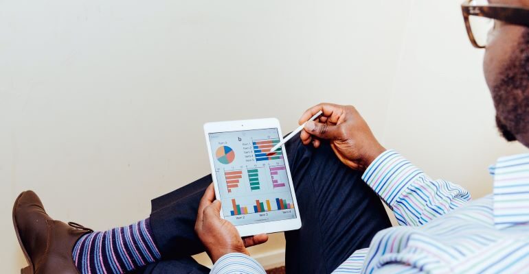 Person looking at tablet with analytics.