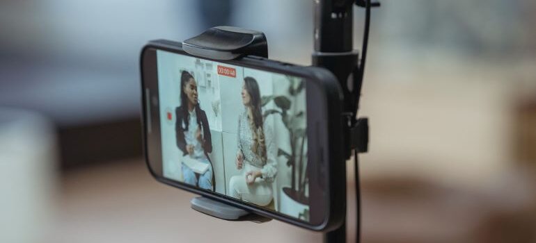 Smartphone recording two women having a discussion.
